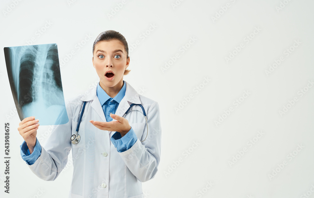 surprised doctor with a stethoscope around the neck in the hands x-ray medicine surprised doctor with a stethoscope around the neck in the hands x-ray medicine