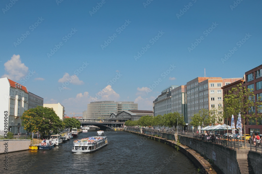 River, cruise motor ships and city. Berlin, Germany