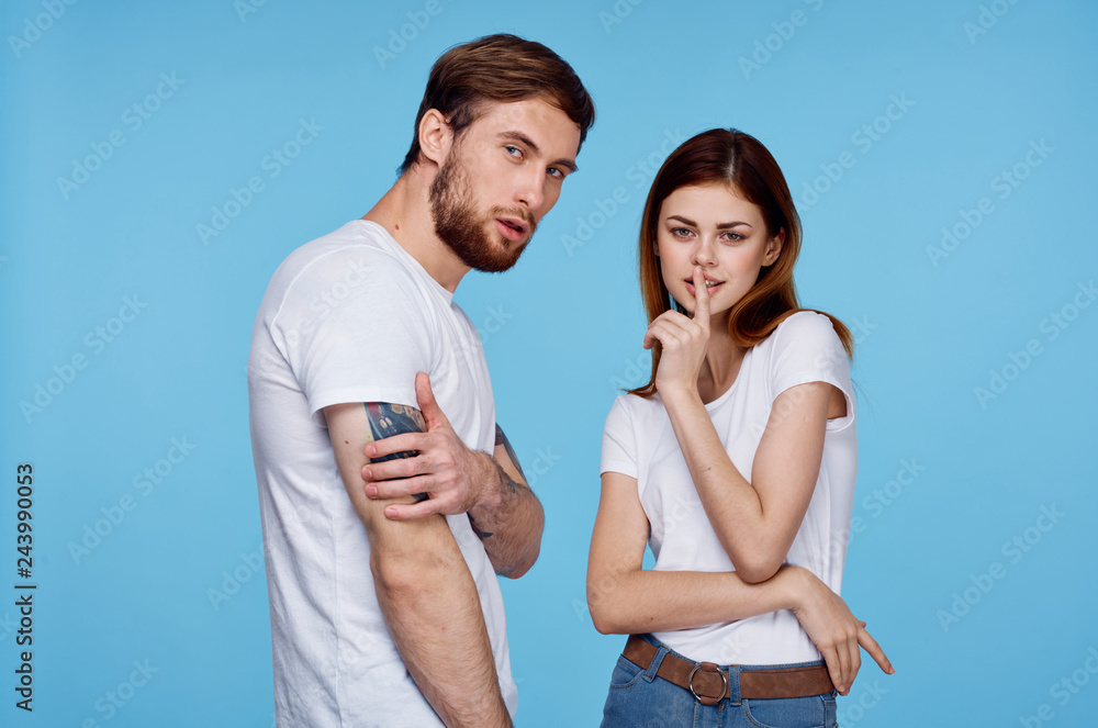 young couple on a blue background man style with a woman tattoo young couple on a blue background man style with a woman tattoo