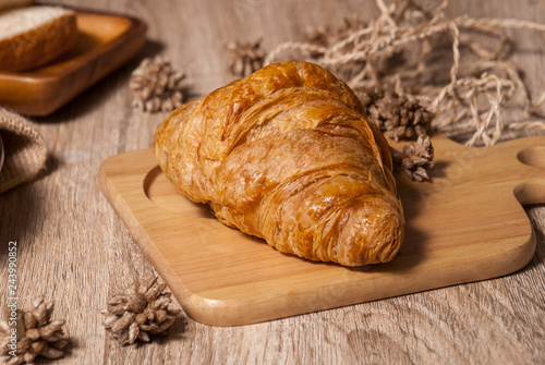 Fresh croissants on a wooden chopping board