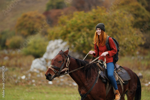 woman riding a horse in nature autumn