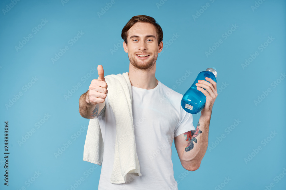 male athlete playing sports on his shoulder towel in hand a bottle of water male athlete playing sports on his shoulder towel in hand a bottle of water