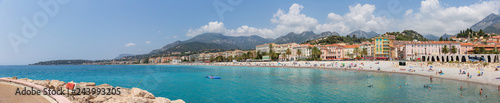Fototapeta Naklejka Na Ścianę i Meble -  Menton France July 9th 2015 : Panoramic view of tourists and locals enjoying the sun on Menton beach in the south of France