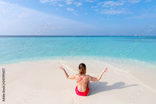 Young fashion woman relax on the beach. Happy island lifestyle. White sand, blue cloudy sky and crystal sea of tropical beach. Vacation at Paradise. Ocean beach relax, travel to Maldives islands