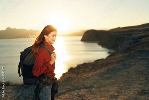 sunset sea nature trip woman with backpack