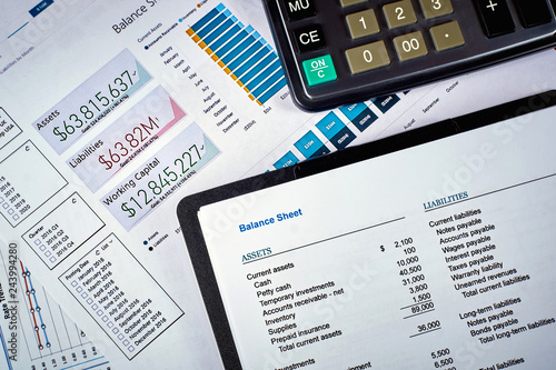 balance sheet and calculator on the background of financial documents, close-up