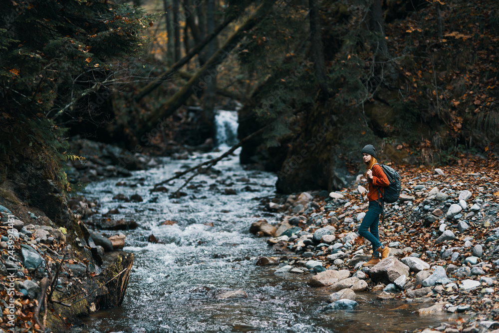 hiking woman with a backpack on the nature of the river autumn hiking woman with a backpack on the nature of the river autumn