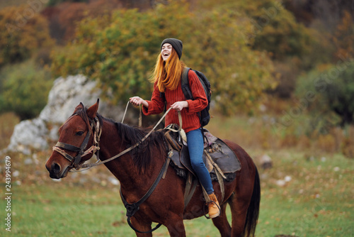 happy woman riding a horse nature autumn trip