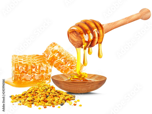 honey dripping in bowl , honeycomb and  bee pollen isolated on a white background