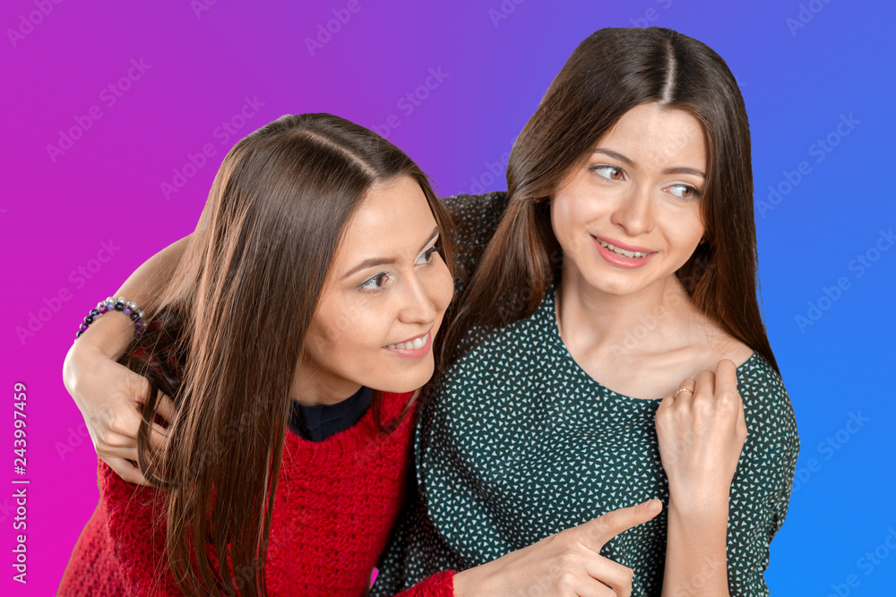 Two beautiful sisters hugging each other and smiling Two beautiful sisters hugging each other and smiling
