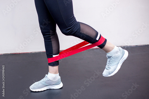 sporty woman doing exercises with a resistance band