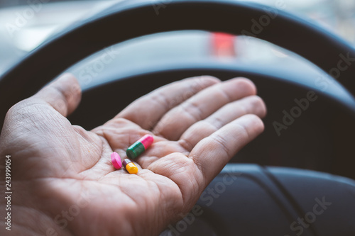 Hand of Man takes drugs in the car photo