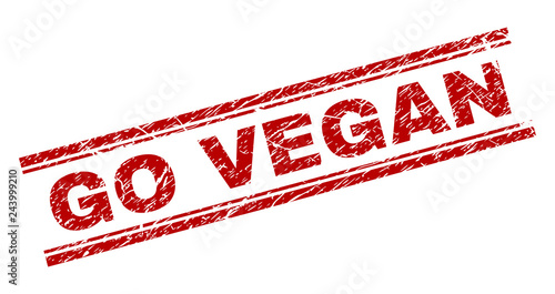 GO VEGAN seal imprint with distress texture. Red vector rubber print of GO VEGAN tag with unclean texture. Text tag is placed between double parallel lines.