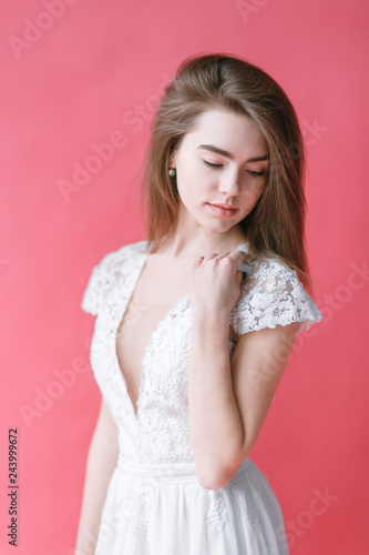 Beautiful young bride in boudoir dress on canvas background with paint. Wedding trends and ideas 2019, spring inspiration.