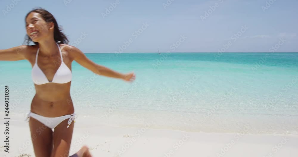 Happiness freedom and joy concept with beach bikini woman jumping cheerful, excited and happy on summer beach vacation travel. RED EPIC SLOW MOTION. Happiness freedom and joy concept with beach bikini woman jumping cheerful, excited and happy on summer beach vacation travel. RED EPIC SLOW MOTION.