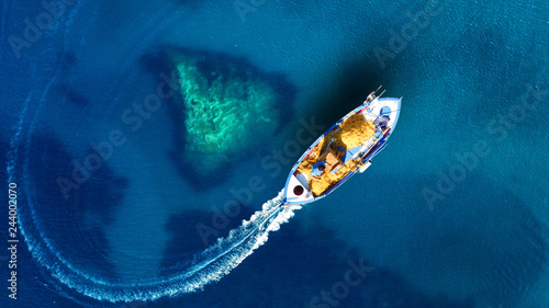 Aerial top view photo of beautiful traditional fishing boat from famous small picturesque village of Parga with turquoise crystal clear sea  Ionian  Greece