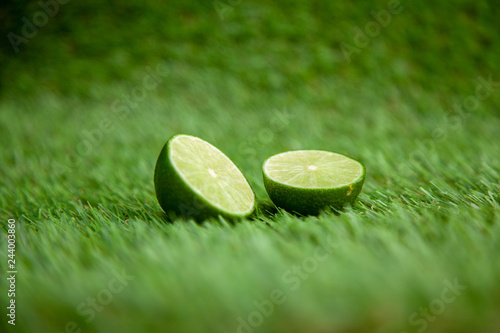halved lime on green grass