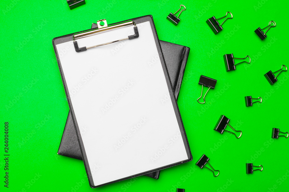 Blank clipboard paper on bright green paper background, copy space Blank clipboard paper on bright green paper background, copy space