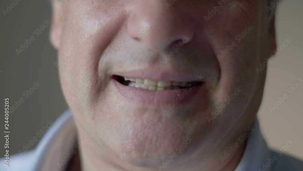 Closeup of middle aged man. Lips of man turning face to camera and smiling. Facial expression concept Closeup of middle aged man. Lips of man turning face to camera and smiling. Facial expression concept