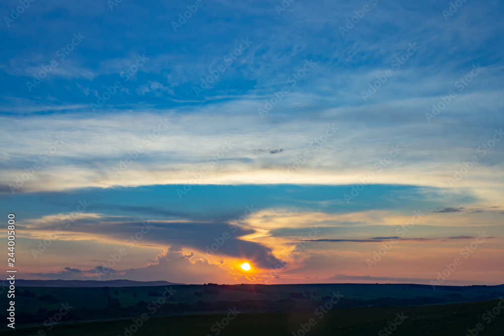 Sunset over the horizon against the blue sky. Sunset over the horizon against the blue sky.