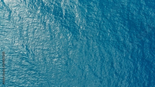 aerial drone image of the deep blue clear sea ocean water with small waves rolling