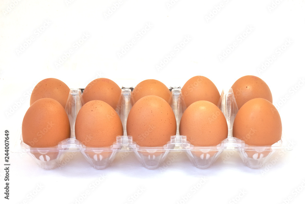 10 eggs in plastic box on white background. 10 eggs in plastic box on white background.
