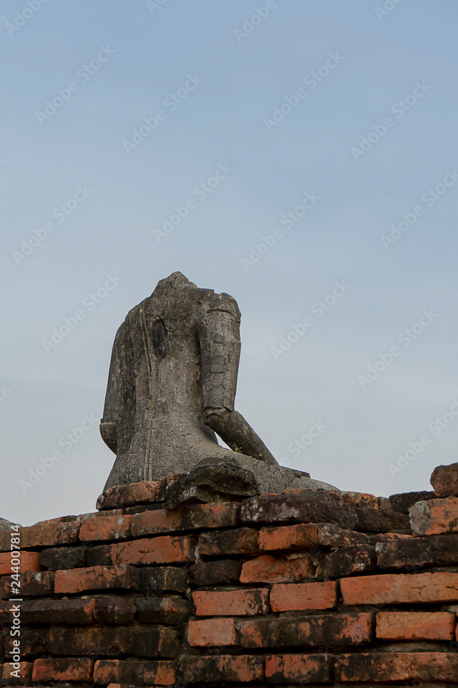Old Buddha statue no head with sky background