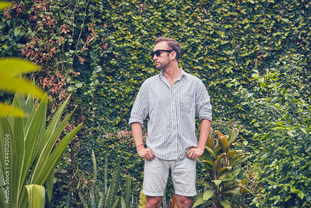 Fototapeta premium Man in summer time outfit posing outdoors.