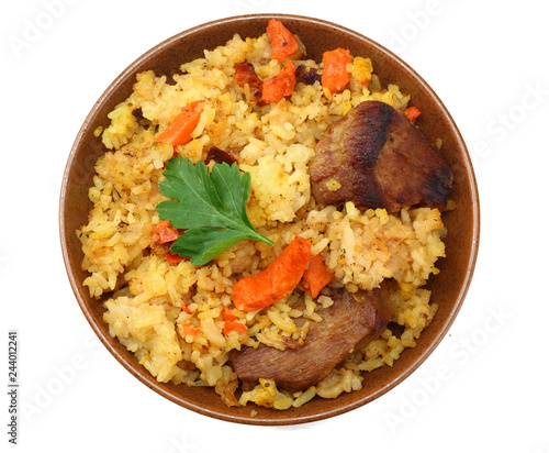 pilaf with meat on brown plate isolated on white background. top view