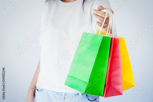 attractive woman hand holding multicolor shopping bags