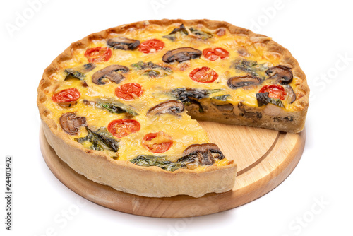 Baked homemade quiche pie on wooden cutting board