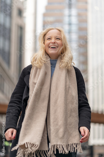 Happy and cheerful businesswoman with blonde hair in the city of London