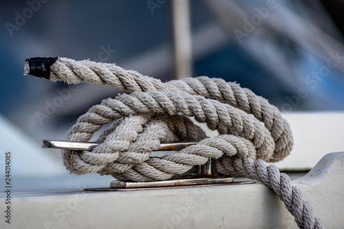 Close up view of white rope tied around ship bollard. © The Walker