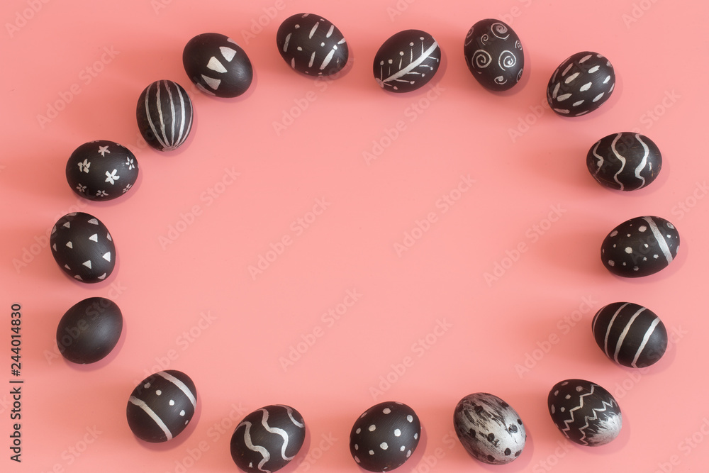 Easter eggs in black on a colored pink background Easter eggs in black on a colored pink background