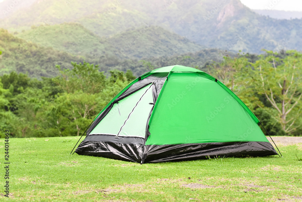 Green color dime tent in mountain range landscapes.