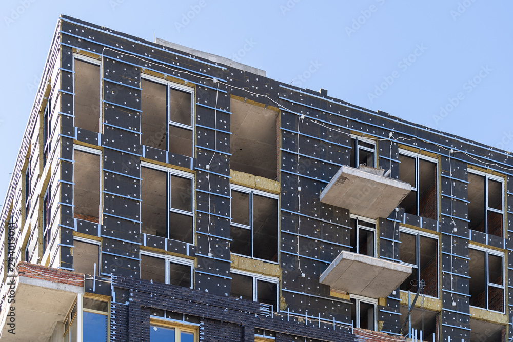 Unfinished building standing against blue peaceful sky - obrazy, fototapety, plakaty 