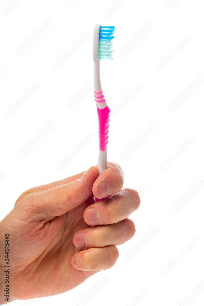 toothbrush in hand on an isolated background toothbrush in hand on an isolated background