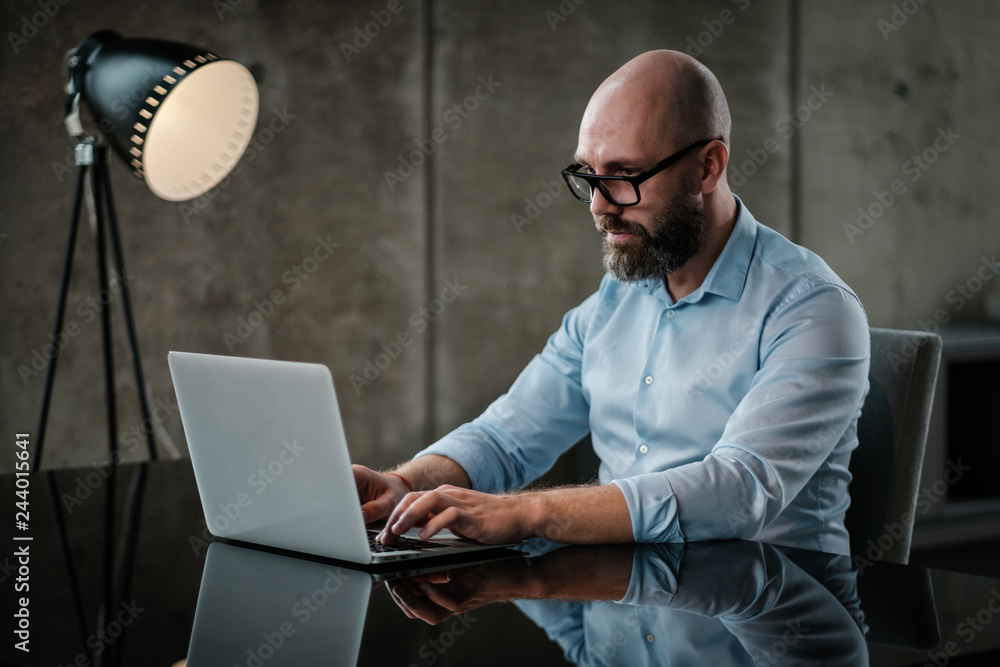 Middle-aged designer working in office Middle-aged designer working in office