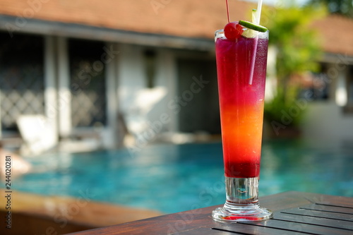 butterfly pea punch mocktail at poolside bar photo