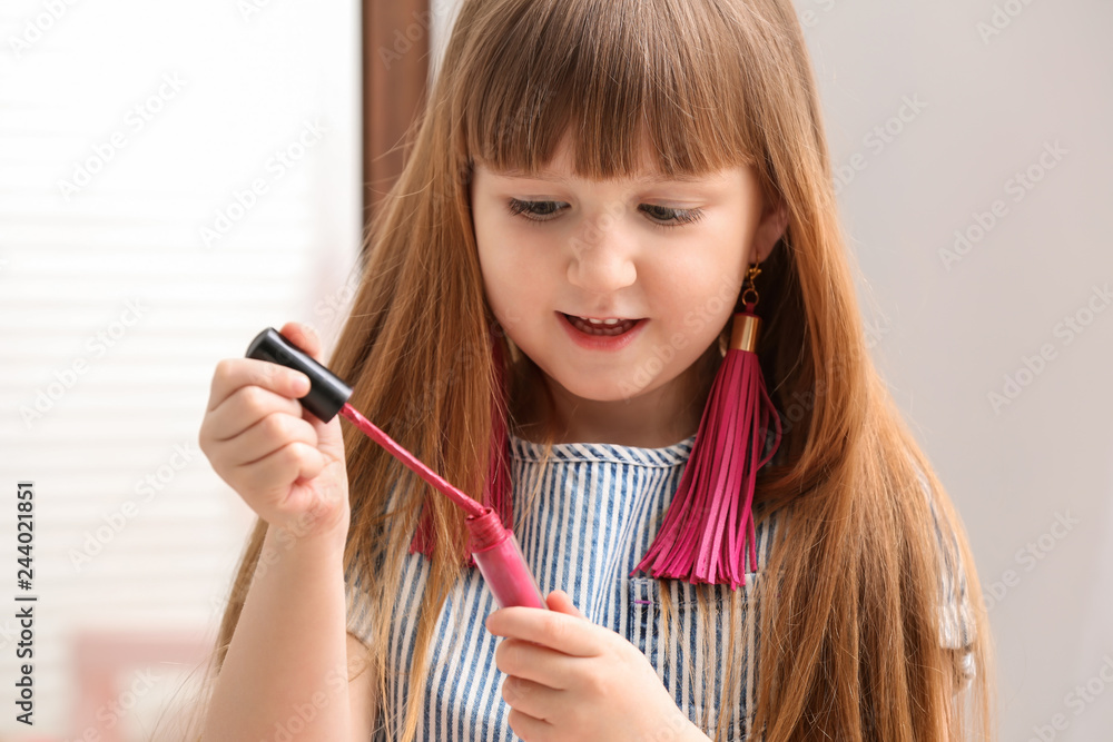 Portrait of cute little fashionista with cosmetics at home Portrait of cute little fashionista with cosmetics at home