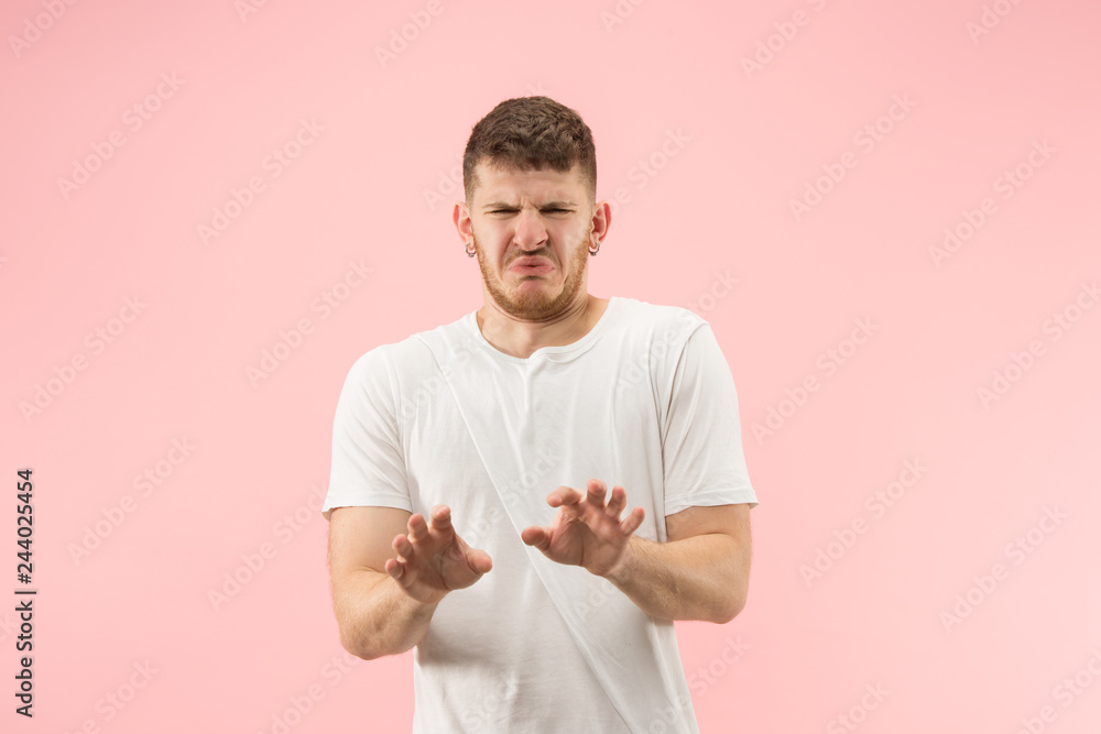 Reject, rejection, doubt concept. Doubtful man with thoughtful expression making choice. Young emotional man. Human emotions, facial expression concept. Studio. Isolated on trendy pink Reject, rejection, doubt concept. Doubtful man with thoughtful expression making choice. Young emotional man. Human emotions, facial expression concept. Studio. Isolated on trendy pink