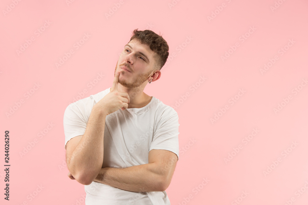 Remember all. Let me think. Doubt concept. Doubtful, thoughtful man remembering something. Young emotional man. Human emotions, facial expression concept. Studio. Isolated on trendy pink Remember all. Let me think. Doubt concept. Doubtful, thoughtful man remembering something. Young emotional man. Human emotions, facial expression concept. Studio. Isolated on trendy pink