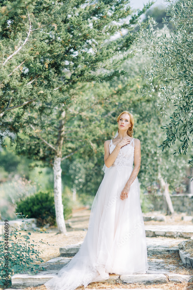 Bride in the mountains with a beautiful view of Cyprus. A wedding dress and a happy girl.