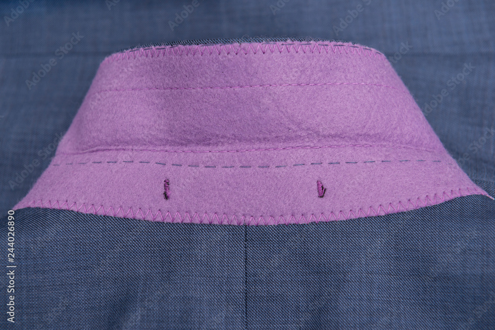 Detalle costura textil, cuello chaqueta