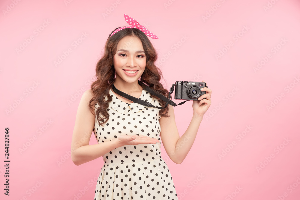 Φωτογραφία Close up portrait of a smiling young girl holding photo camera isolated on a pin