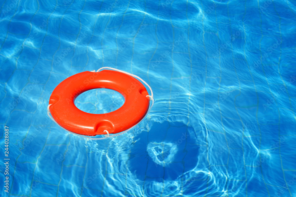 Colorful lifeguard tube floating in swimming pool Colorful lifeguard tube floating in swimming pool
