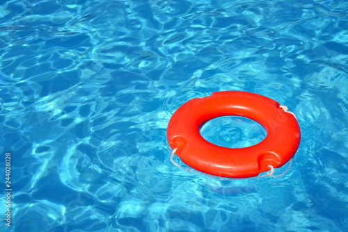 Colorful lifeguard tube floating in swimming pool