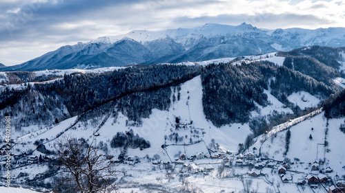 Brasov - Romania, Rucar - Bran snowy picturesque hills on a sunny cold December. Wide panorama of the Carpathian mountains. © Daniel Avram
