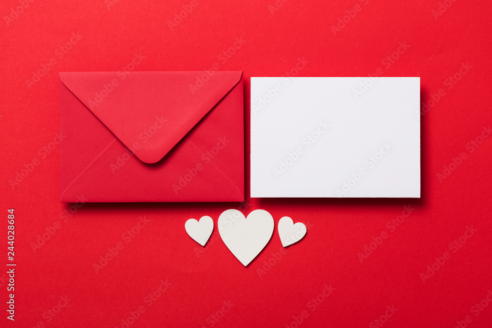 Valentine's day love letter mockup. Red envelope blank white card and hearts Valentine's day love letter mockup. Red envelope blank white card and hearts