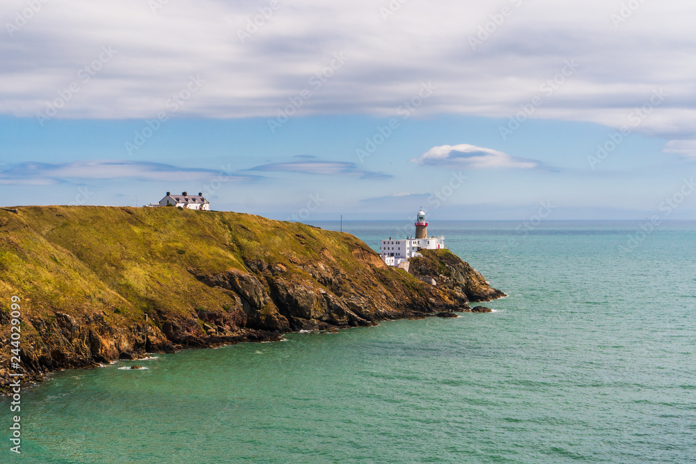Baily Lighthouse as seen from the Cliff Walk in Howth, Dublin, Ireland. Beautiful Irish landscape.